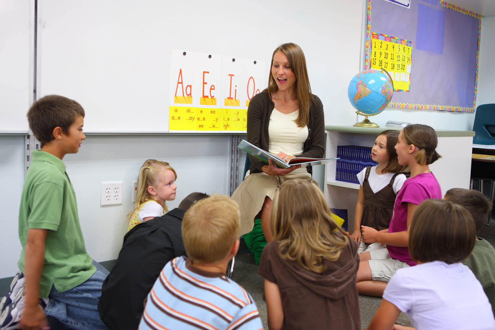 bigstock-Elementary-school-teacher-read-14086283 copy